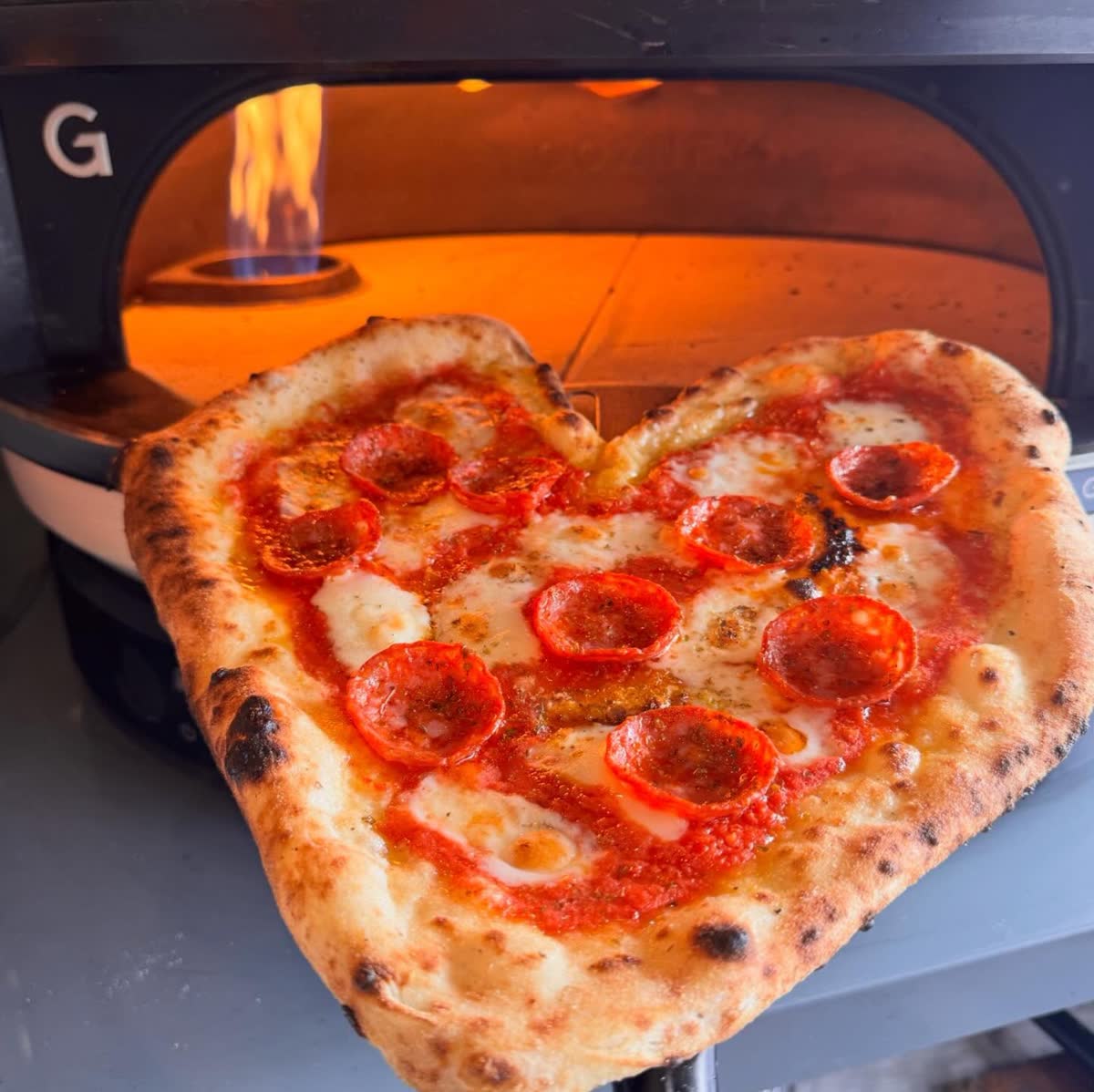 Heart-shaped pepperoni pizza from Gozney oven - perfect for weddings